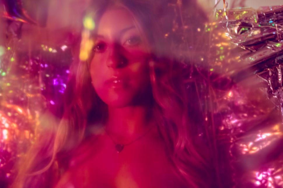 Free Image of Woman with sparkling effects in foreground 