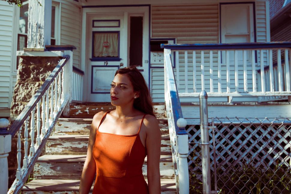 Free Image of Woman in front of old house 