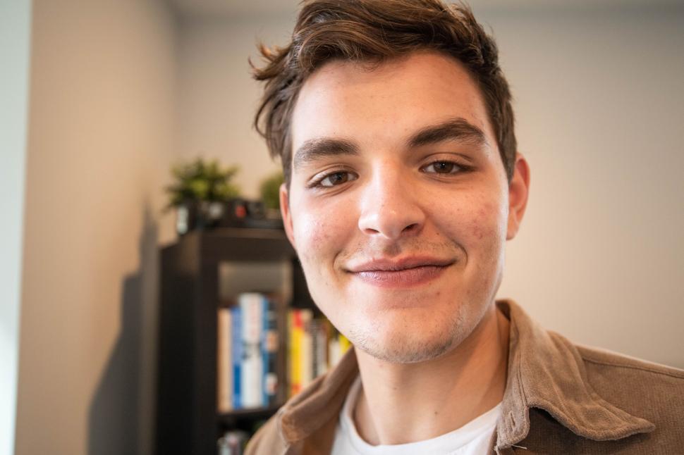 Free Image of Smiling young man in casual attire indoors 