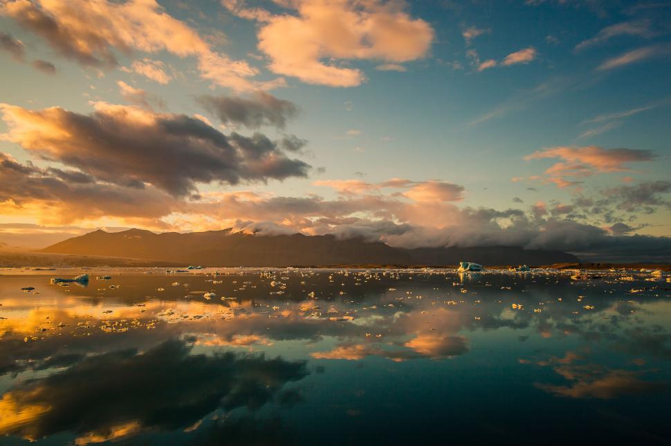 Free Image of Golden sunset reflecting on a tranquil lake 