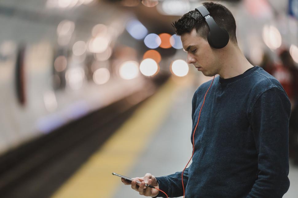 Listener with headphones using smartphone