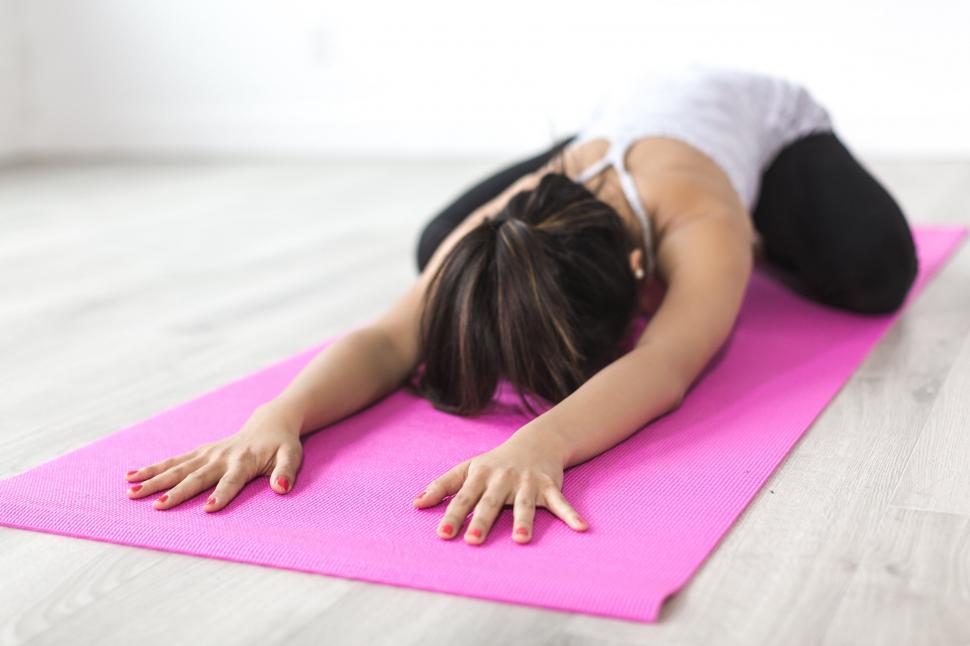 woman-practicing-yoga-on-a-pink-mat.jpg