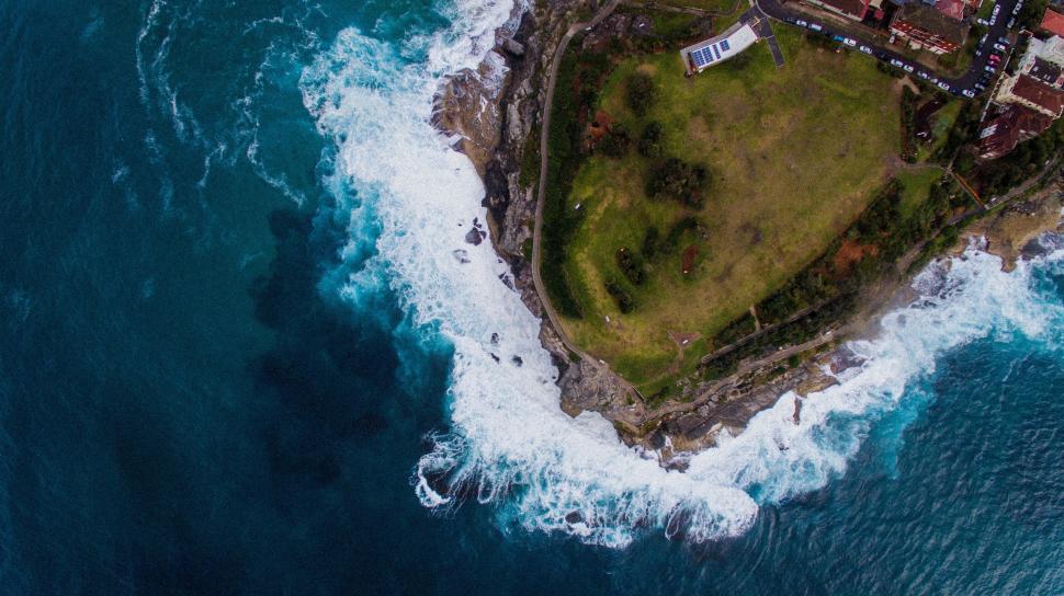 Free Image of Aerial view of rocky coastline and waves 