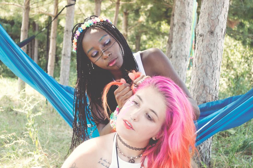 Free Image of Woman with colorful hair relaxing in hammock 