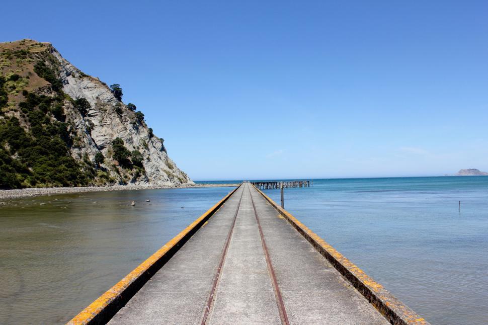 Free Image of Lonely pier leading into serene ocean 