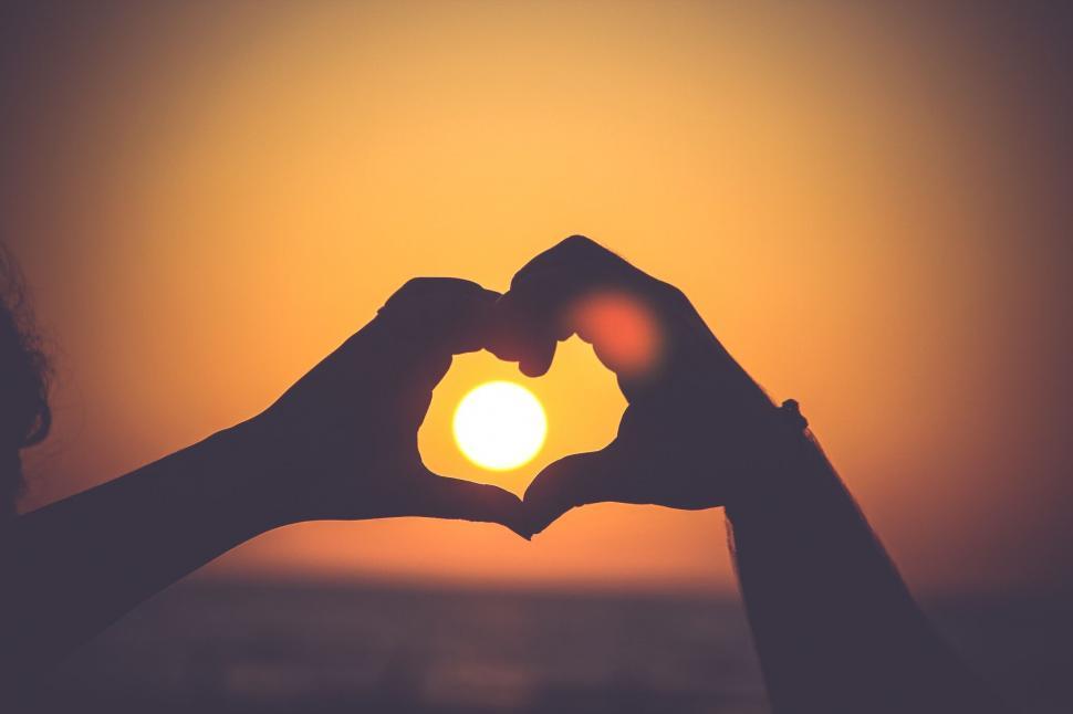Free Image of Silhouettes Forming a Heart Shape at Sunset 