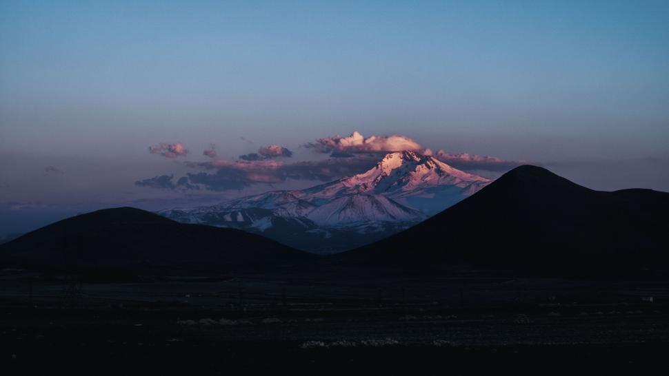 Free Image of Silhouettes of hills with snow-capped mountain 