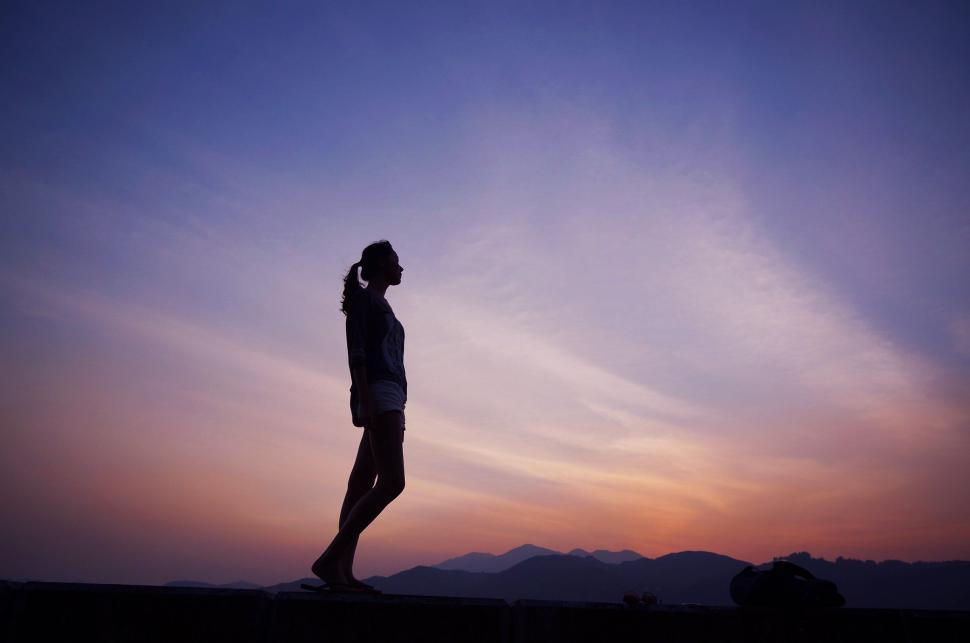 Free Image of Silhouette of a woman against twilight sky 