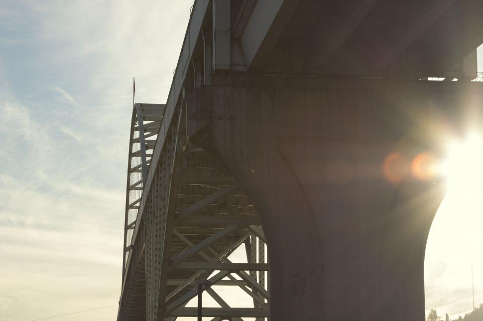 Free Image of Sun Flare Beneath Large Bridge Structure 