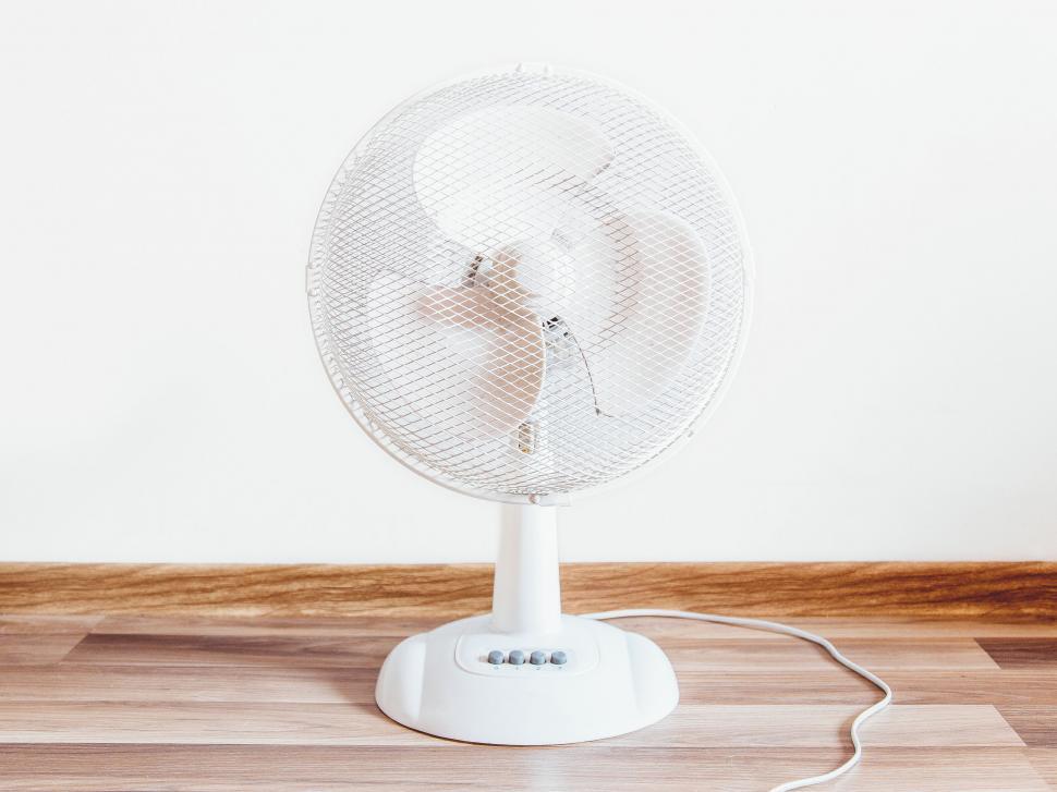 Free Image of Electric table fan on a wooden desk 
