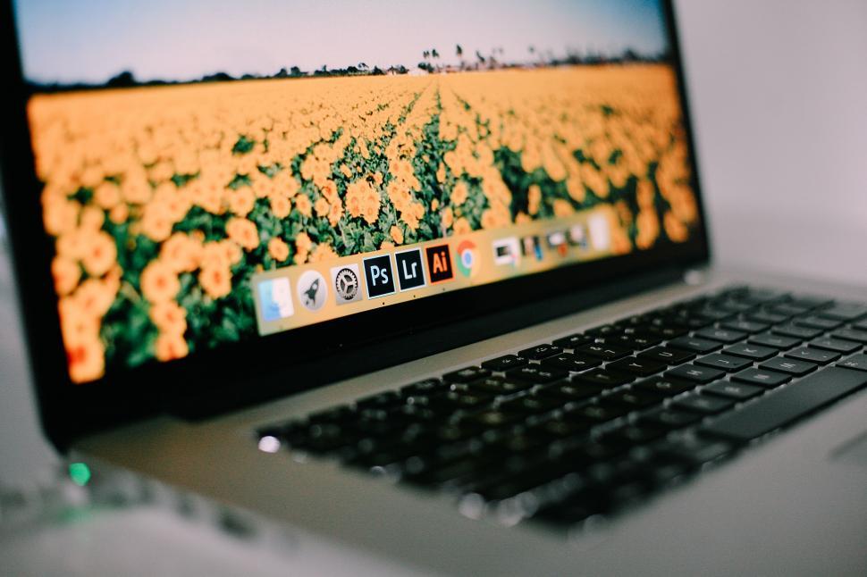 Free Image of Laptop with colorful wallpaper and editing apps 