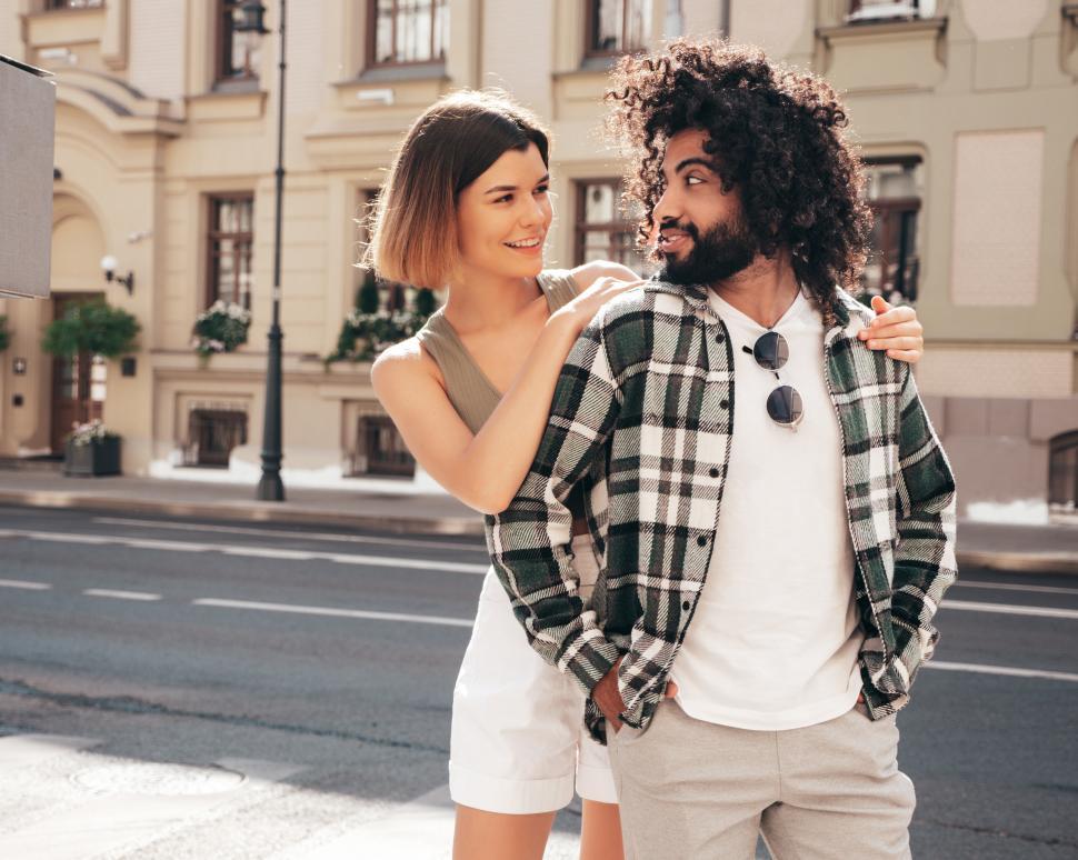 Free Image of A woman hugging a man on a street 