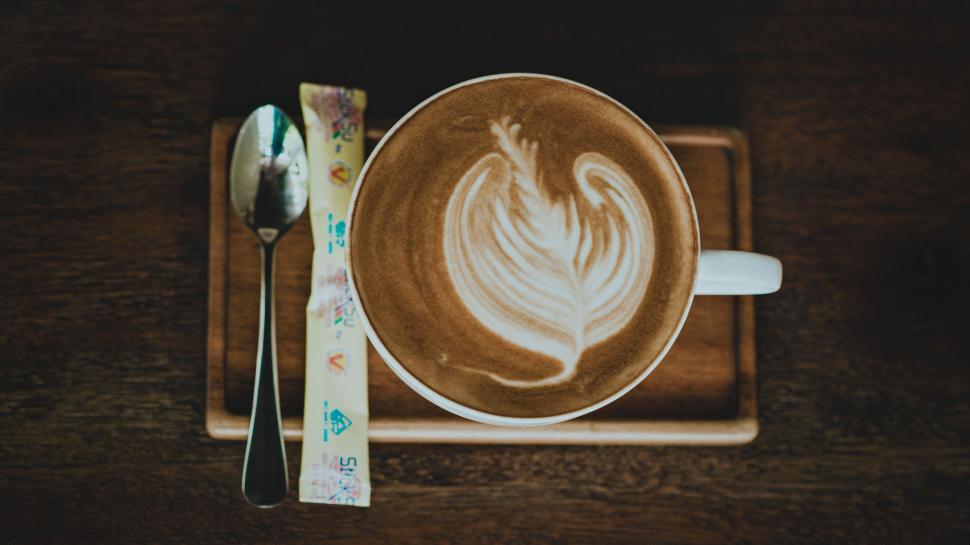 Free Image of Top view of a latte art coffee on table 