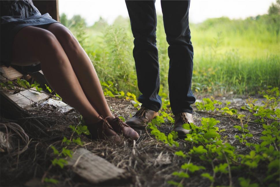 Free Image of Couple sitting together on a rustic bench 