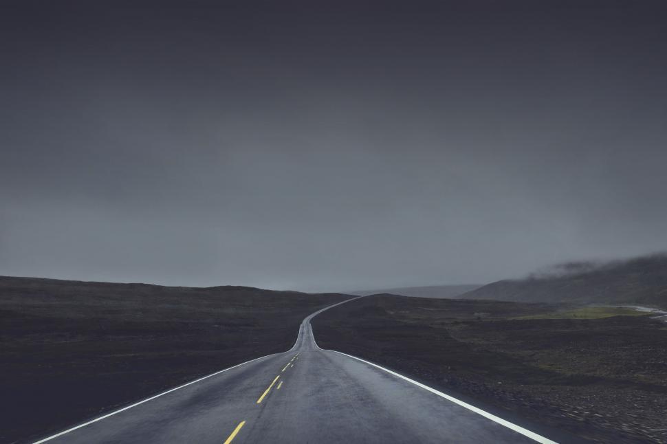 Free Image of Mysterious foggy road in monochrome tones 
