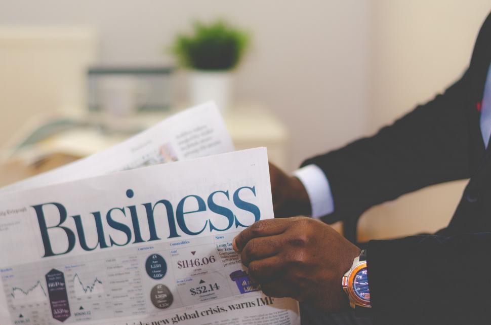 Free Image of Man reading financial news on newspaper 