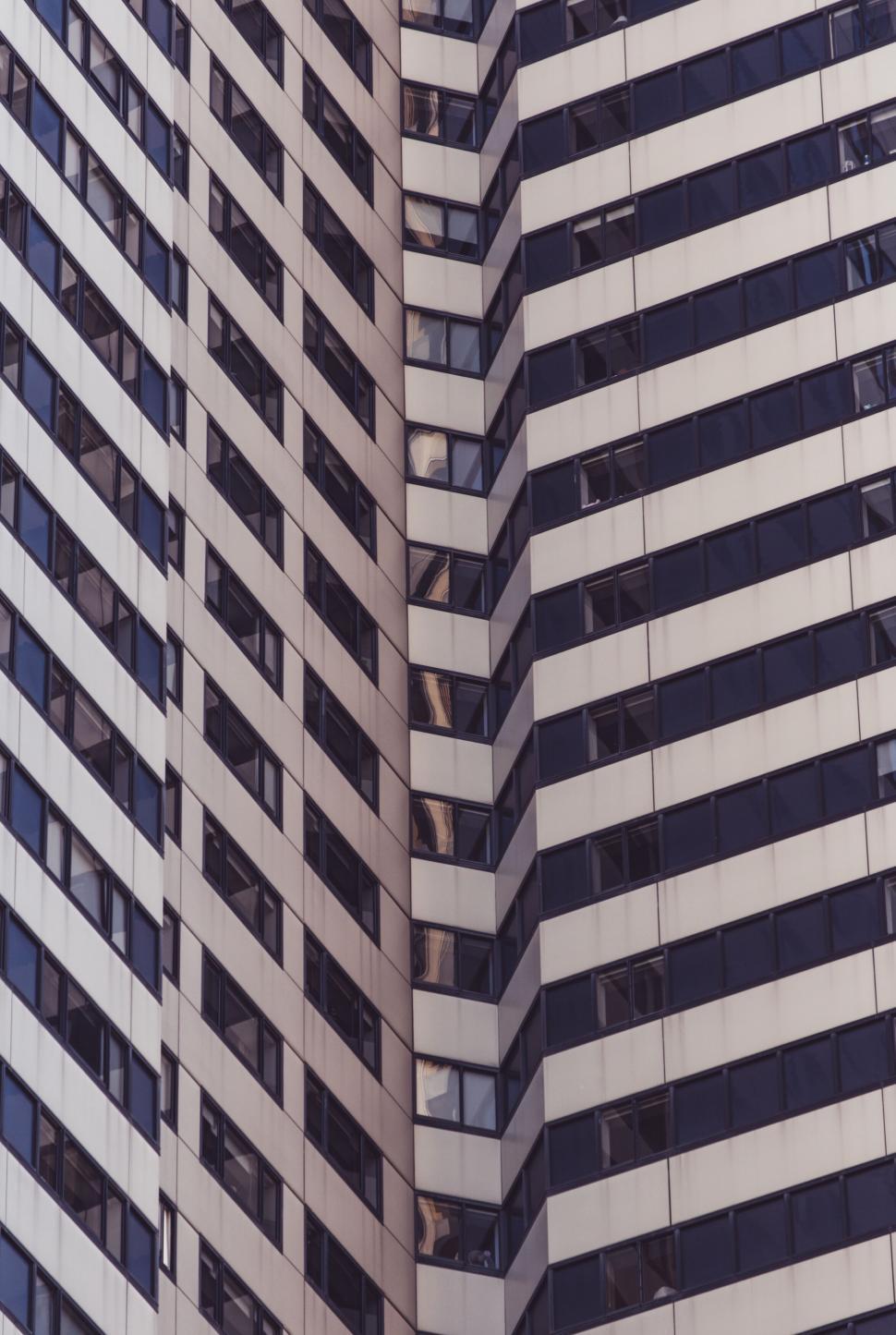 Free Image of Abstract pattern of curved building windows 