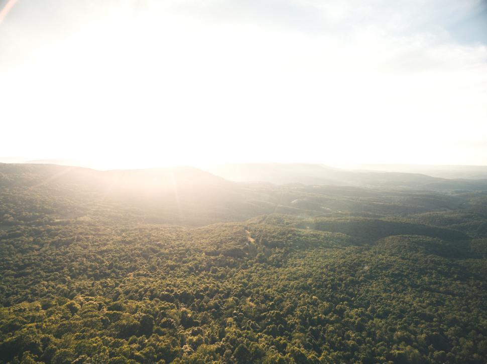 Free Image of Sunlight breaking over lush mountain landscape 