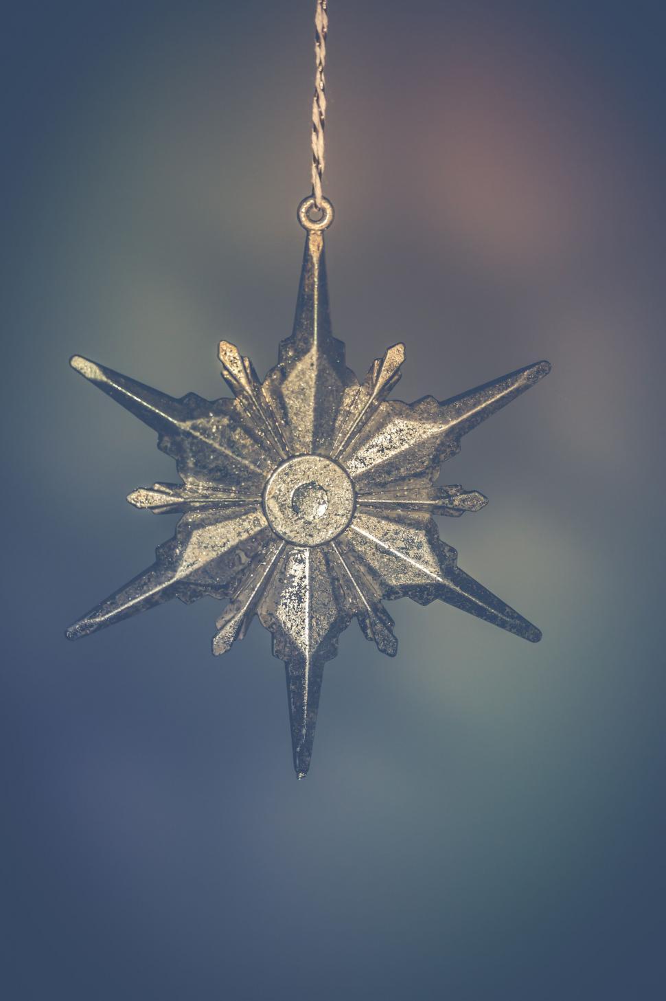 Free Image of Vintage star-shaped Christmas ornament hanging 
