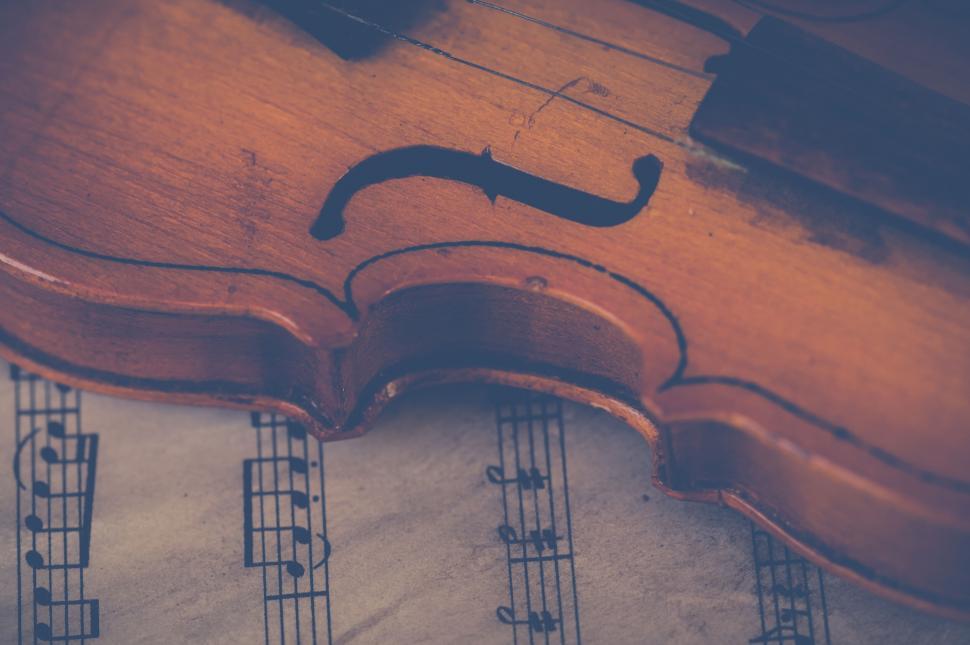 Free Image of Vintage violin on sheet music background 