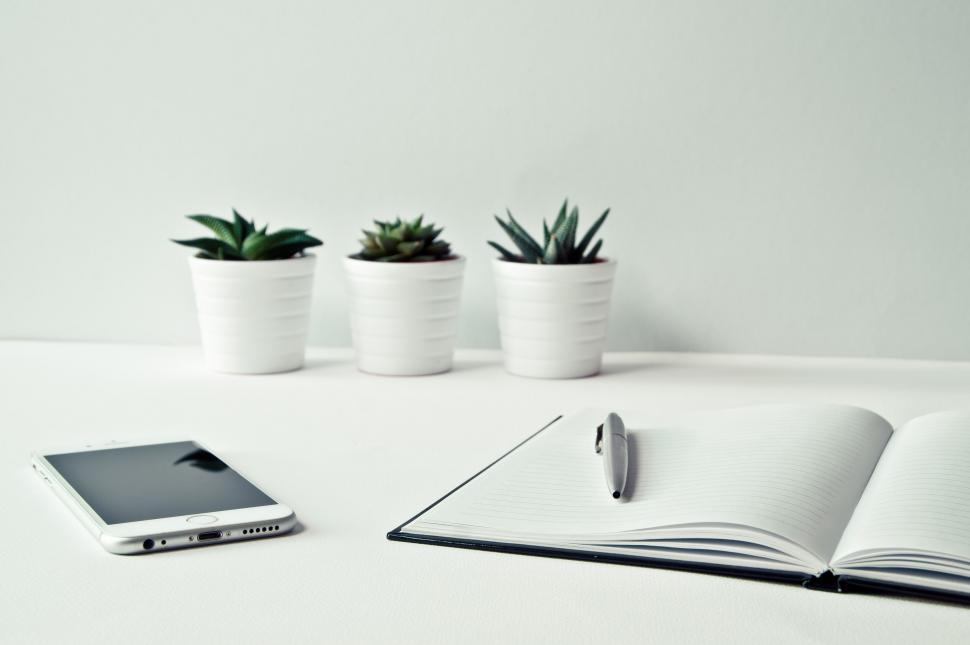 Free Image of Open notebook, phone, and pen on desk 