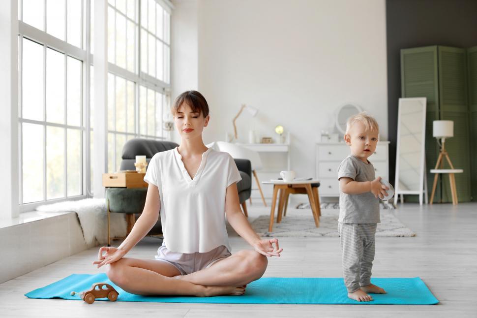 Free Image of Mother meditating with baby around 