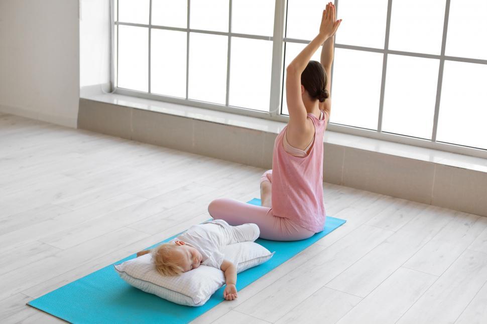 Free Image of Yoga practice in a bright room with child 