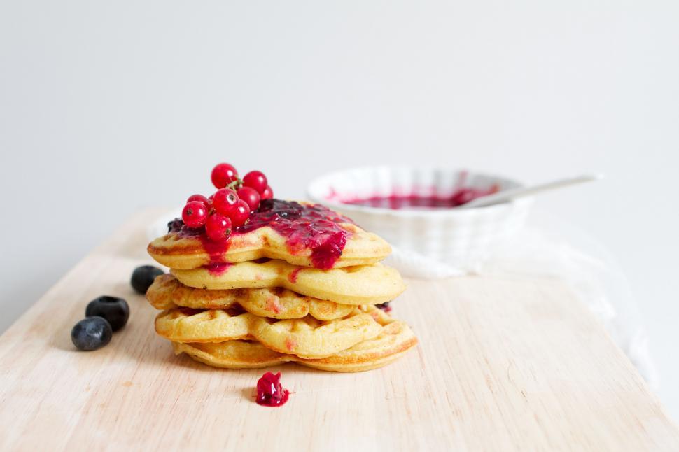 Free Image of Stack of pancakes with berries on board 