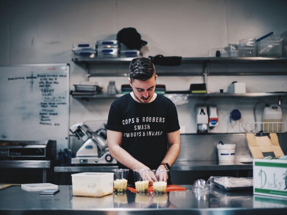 Free Image of Chef preparing food in a commercial kitchen 