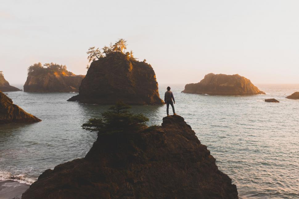 Free Image of Person on a rock overlooking ocean 