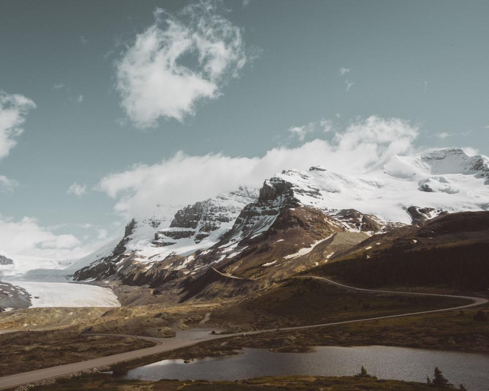 Free Image of Scenic view of snow-capped mountains and lake 