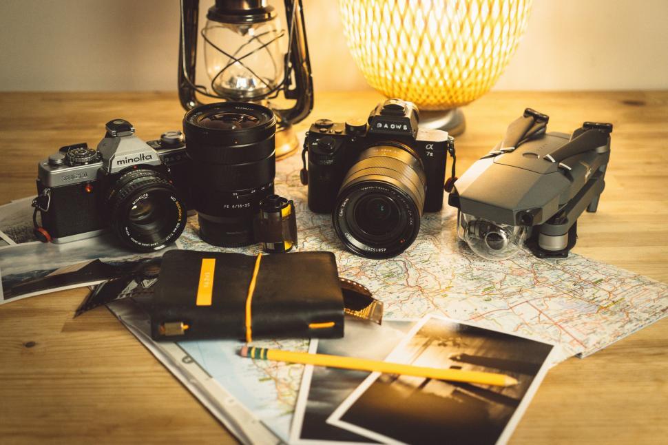 Free Image of Vintage cameras and travel gear on table 