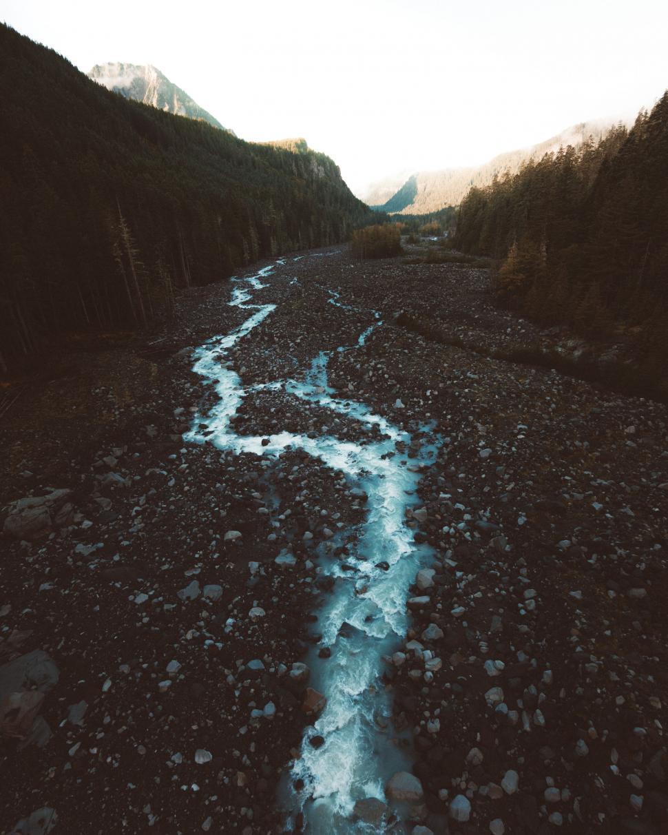 Free Image of Stream winding through rocky terrain 