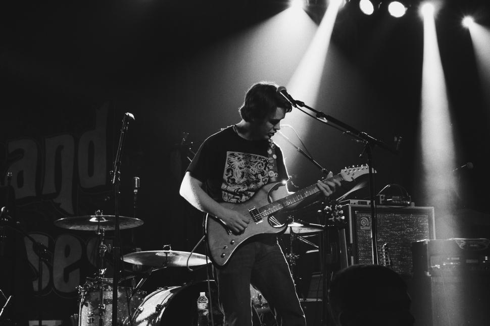 Free Image of Monochrome image of a guitarist on stage 
