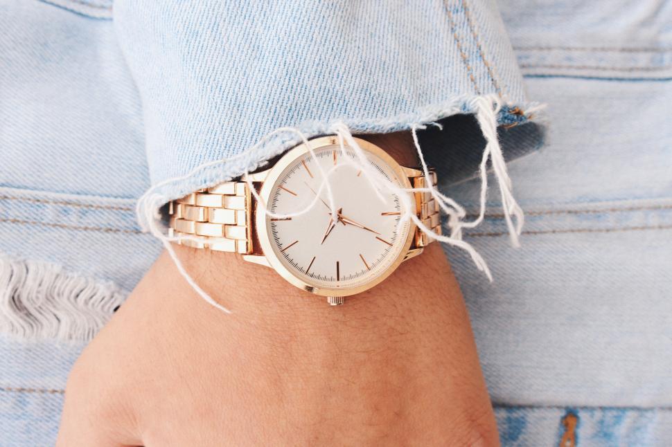 Free Image of Person showing a gold wristwatch 