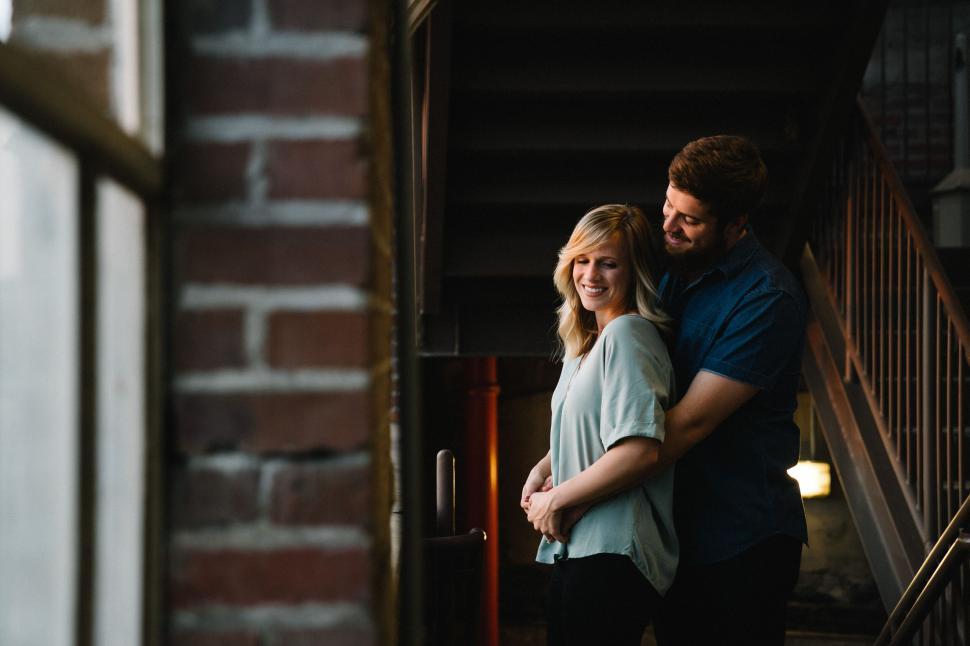 Free Image of Couple embracing on a stairway 