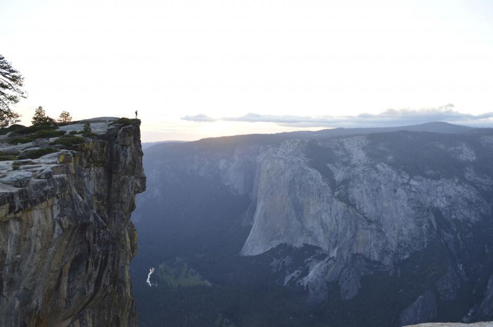 Free Image of Person on a cliff overlooking a valley 