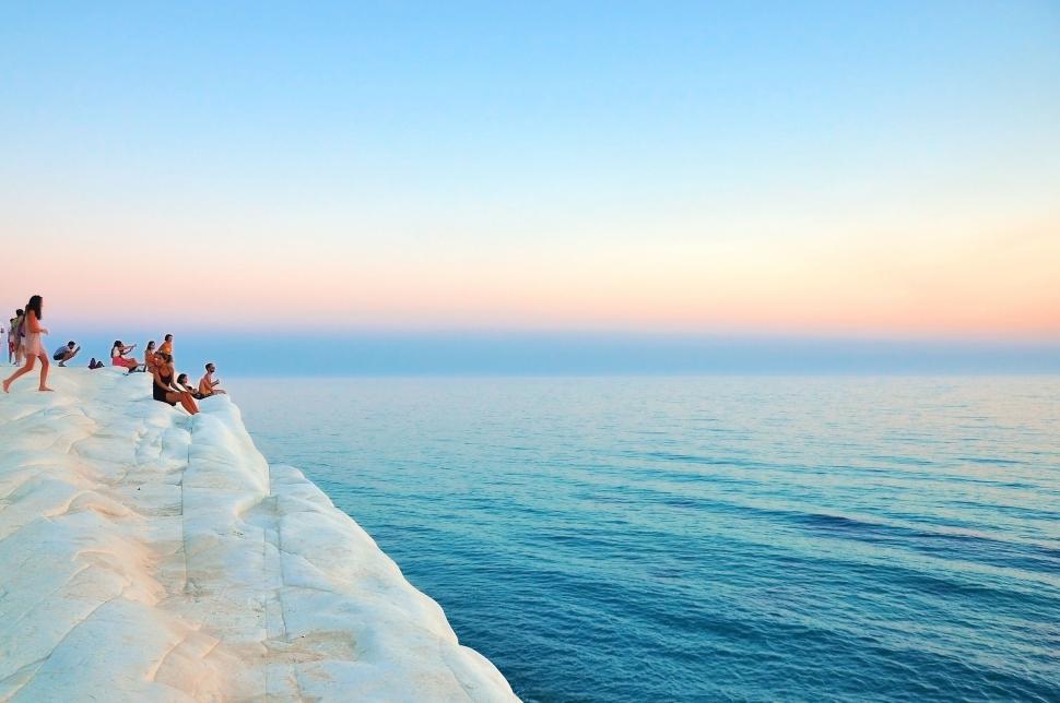 Free Image of People relaxing on a calm chalk cliff 