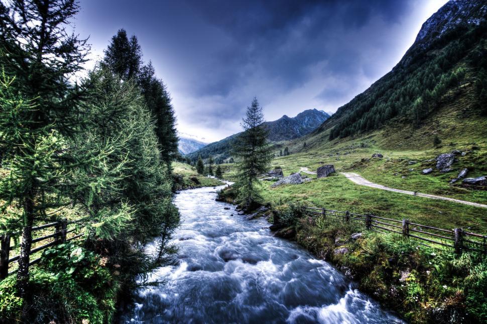 Free Image of Rapid river flowing through a valley 