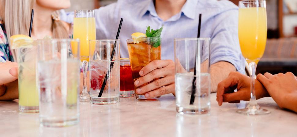 Free Image of Friends Enjoying Drinks at a Marble Bar 
