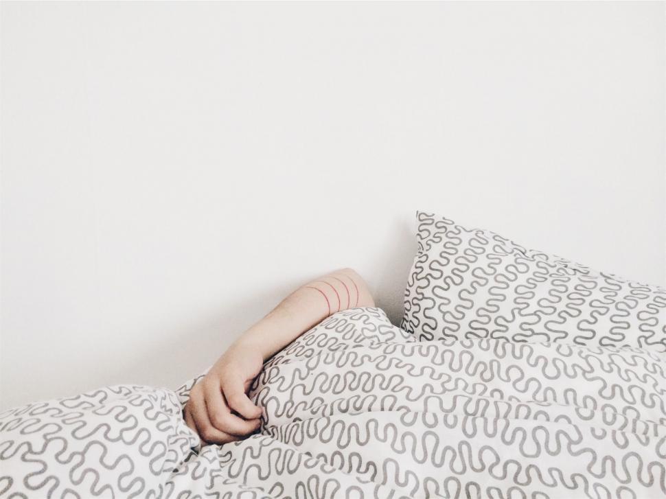 Free Image of Person hidden under bed sheets 