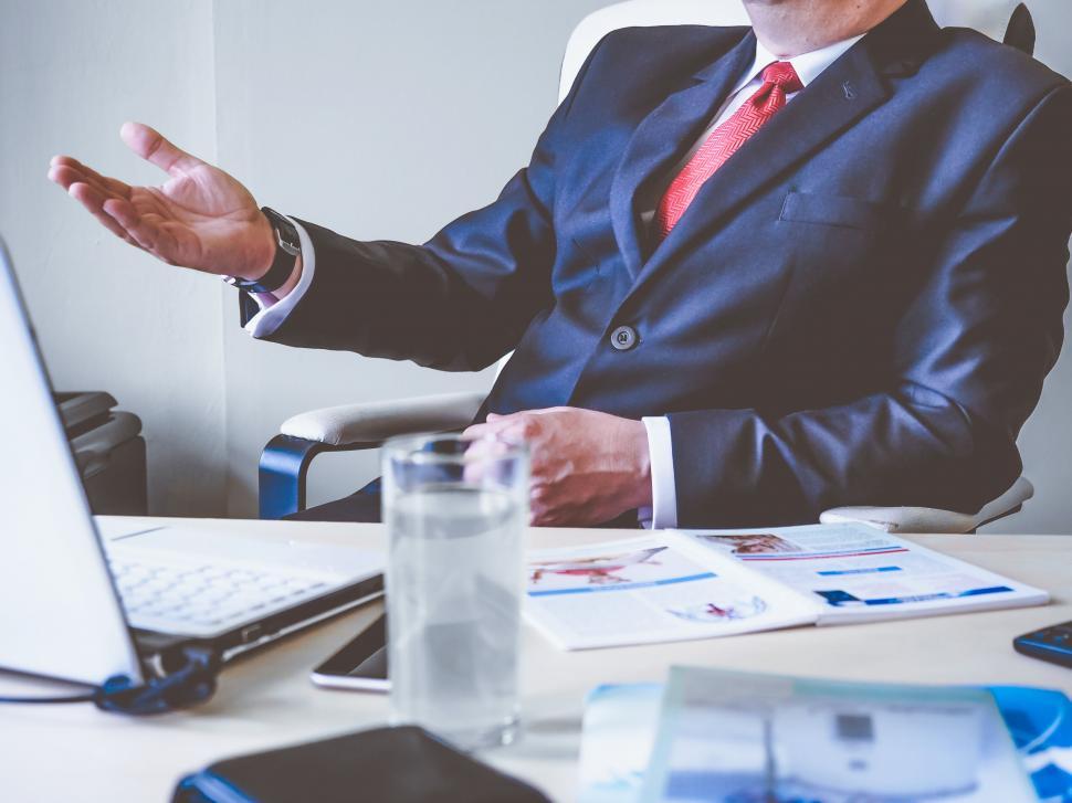 businessman-presenting-in-office-with-laptop.jpg