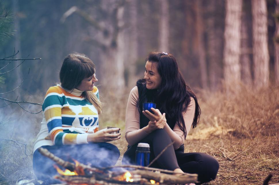 Free Image of Friends enjoying a campfire in the woods 