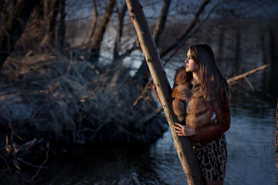 Free Image of Woman in winter attire by a river 