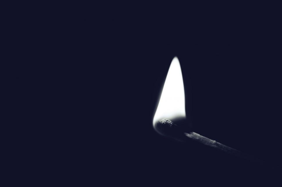 Free Image of Illuminated matchstick on dark background 