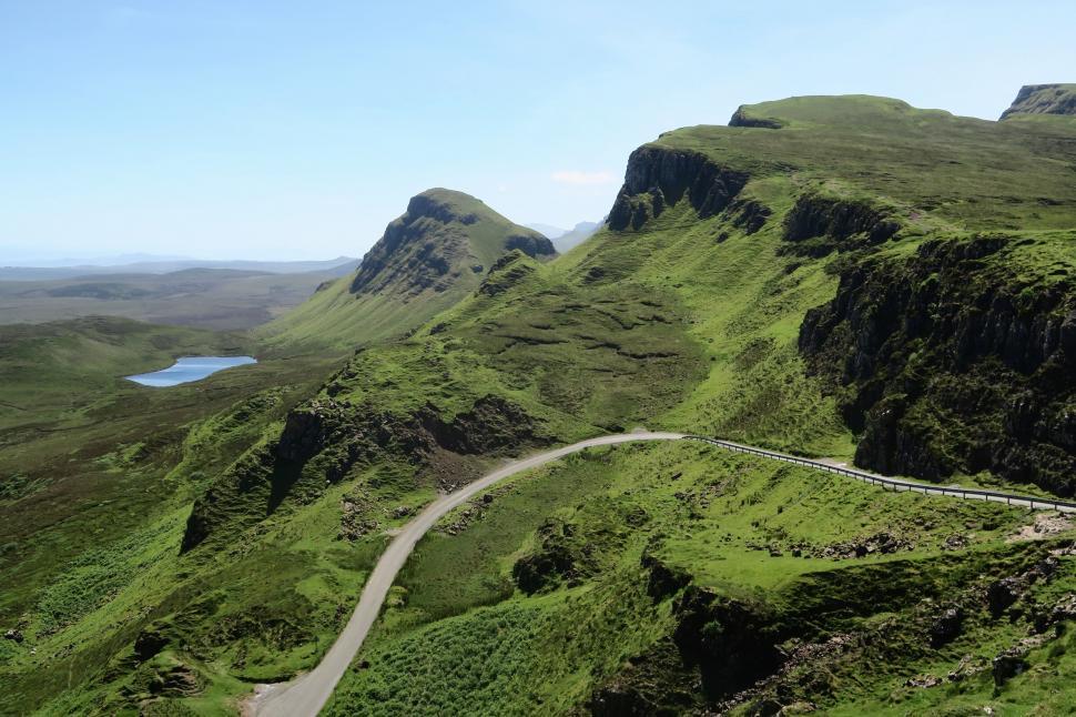 Free Image of Winding road through lush green hillsides 