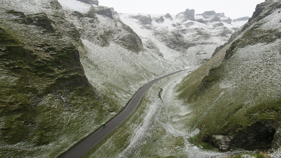 Free Image of Snow dusted mountain pass with winding road 