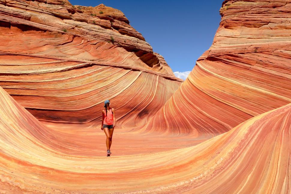 Free Image of Person in front of striped rock formations 