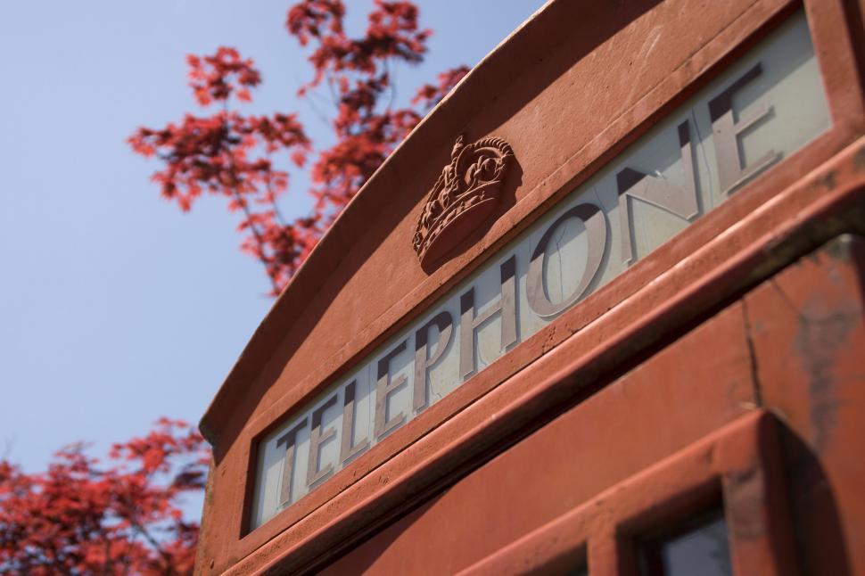 Free Image of Red UK telephone box with blooming tree 