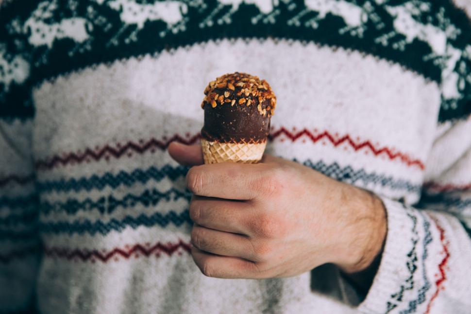 Free Image of Man holding a chocolate-topped ice cream 